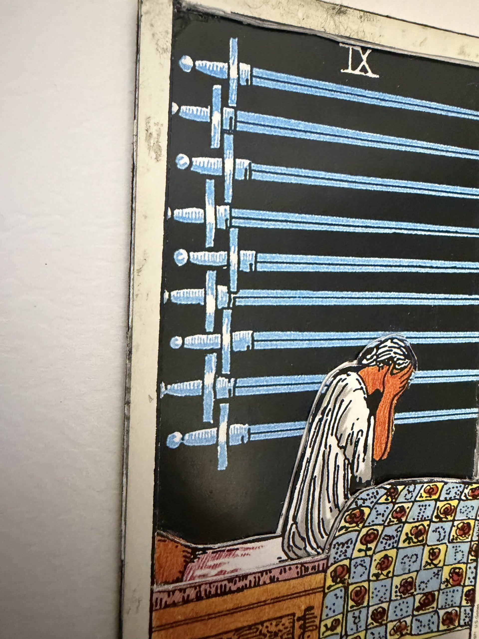 3D layered Nine of Swords tarot card showing detailed sword alignment and raised figure